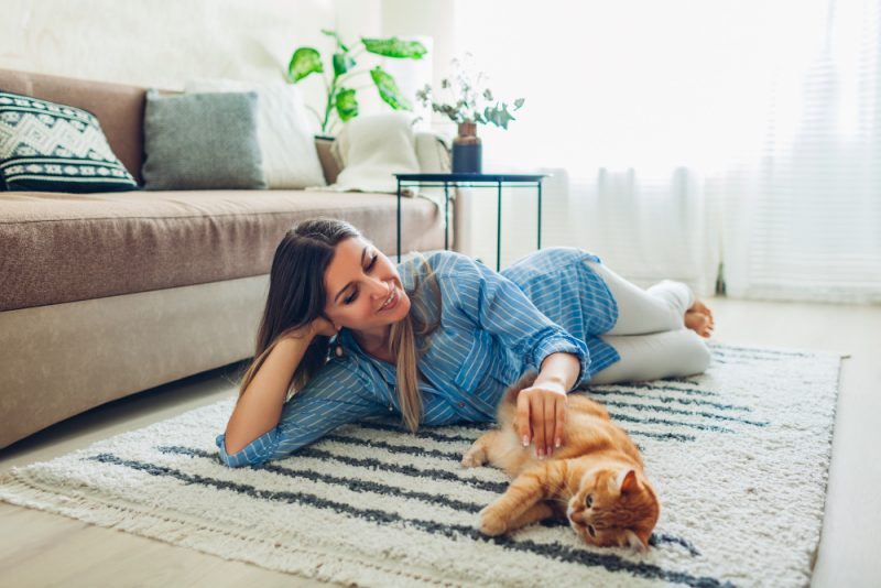 kobieta z kotem na dywanie